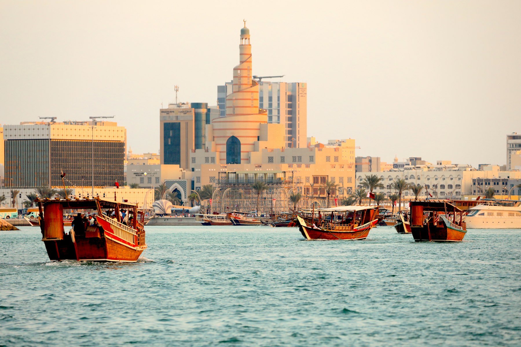 Dhow boats on Doha bay with the West Bay skyline