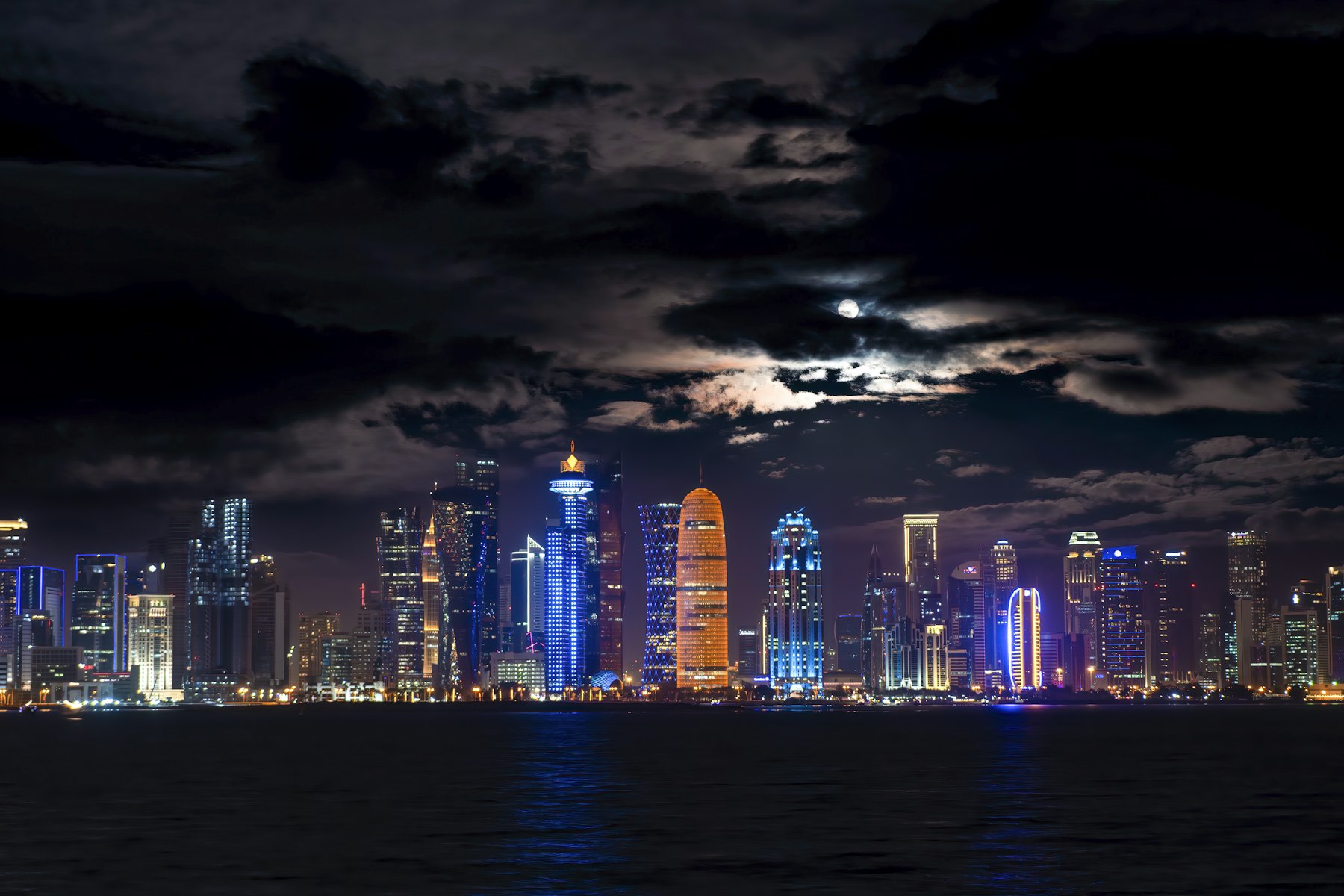 Doha city skyline under a full moon
